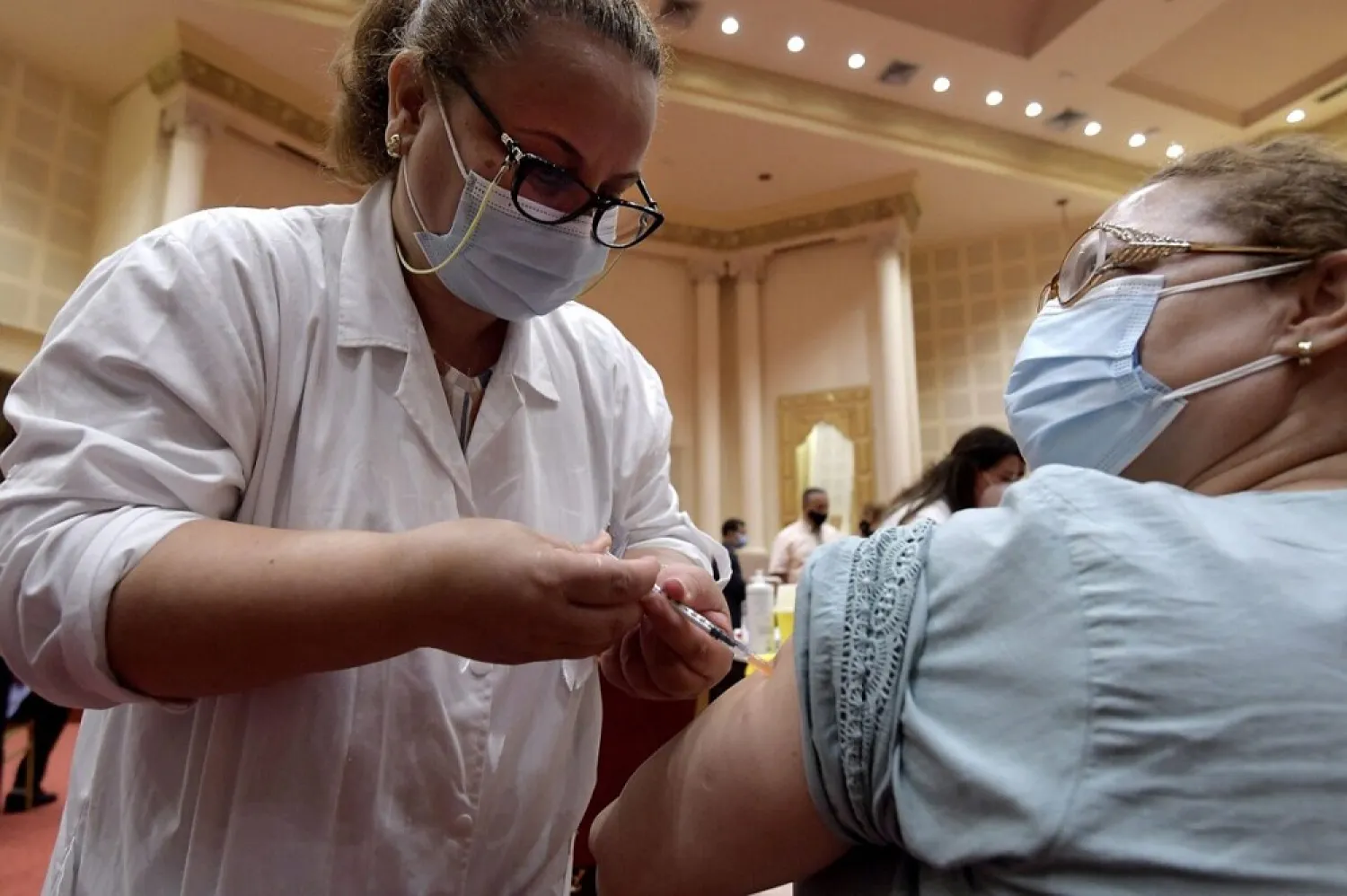 Tunisians working in the tourism industry receive a dose of the Pfizer-BioNTech COVID-19 coronavirus vaccine in Tunis on June 4. (Getty Images)