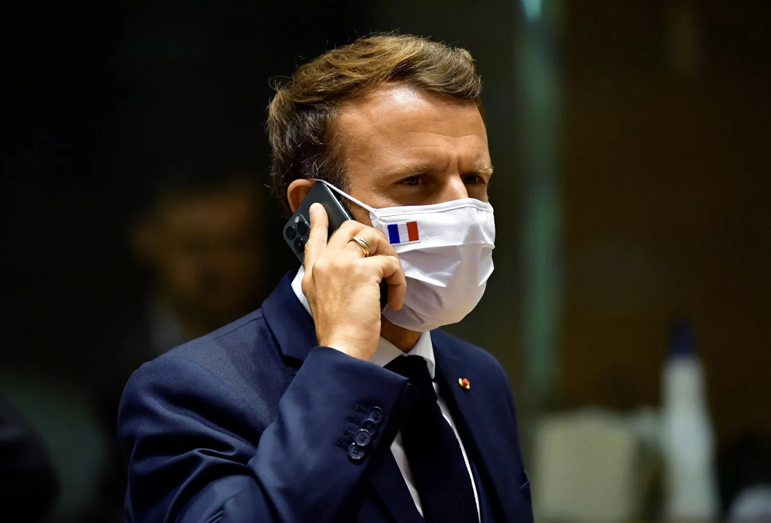 FILE - In this Monday, July 20, 2020 file photo, French President Emmanuel Macron speaks on his mobile phone during a round table meeting at an EU summit in Brussels. (John Thys, Pool Photo via AP, File)