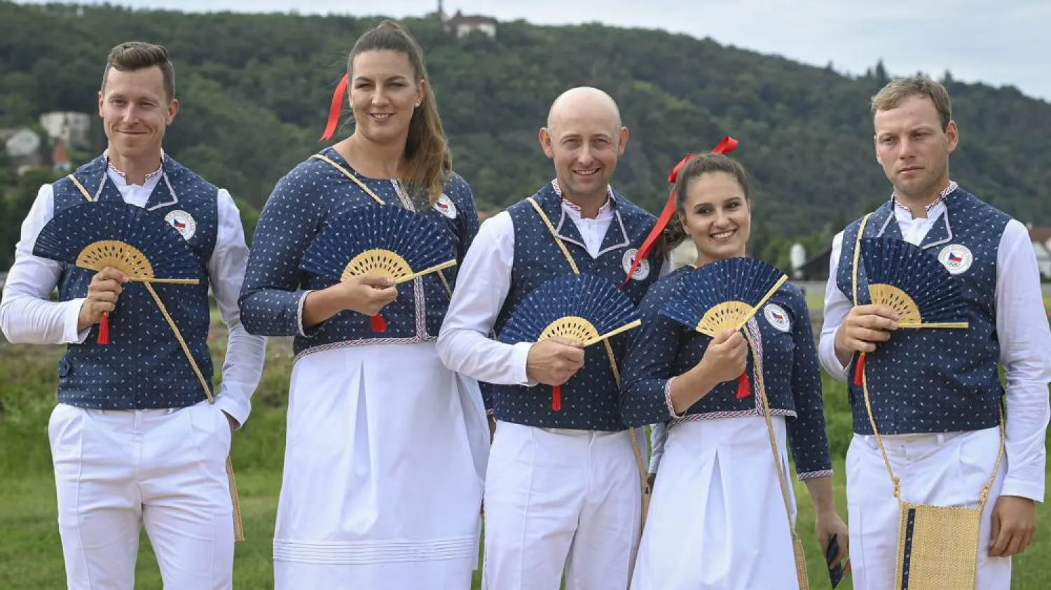 From left, Czech track cyclist Tomas Babek, hammer thrower Katerina Safrankova, rider Miroslav Trunda, artistic gymnast Aneta Holasova and rider Miloslav Prihoda, pose wearing the new Olympic uniforms for The Tokyo Olympic Summer Games 2020, in Prague, Czech Republic, Tuesday, June 22, 2021. (AP)