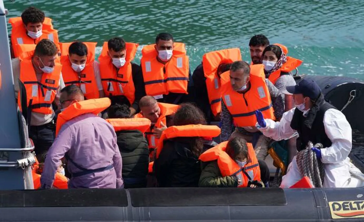 A group of people thought to be migrants are brought into port aboard a border force boat following a small boat incident in the Channel, at Dover, southern England, Wednesday July 21, 2021 (Gareth Fuller/PA via AP)
