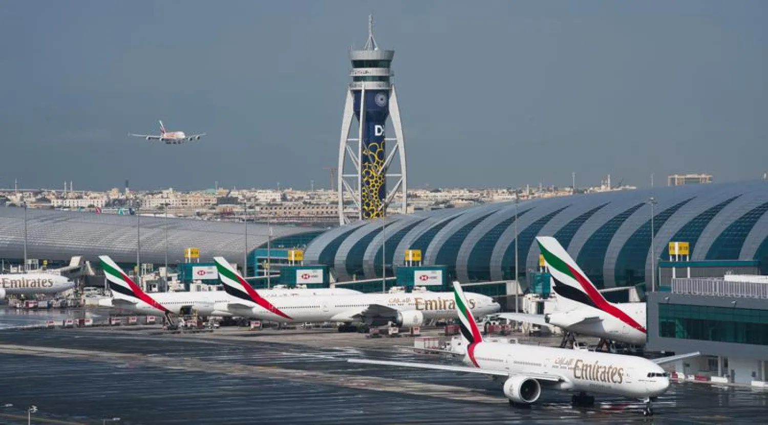 FILE - In this Dec. 11, 2019, file photo, an Emirates jetliner comes in for landing at the Dubai International Airport in Dubai, United Arab Emirates. (AP Photo/Jon Gambrell, File)
