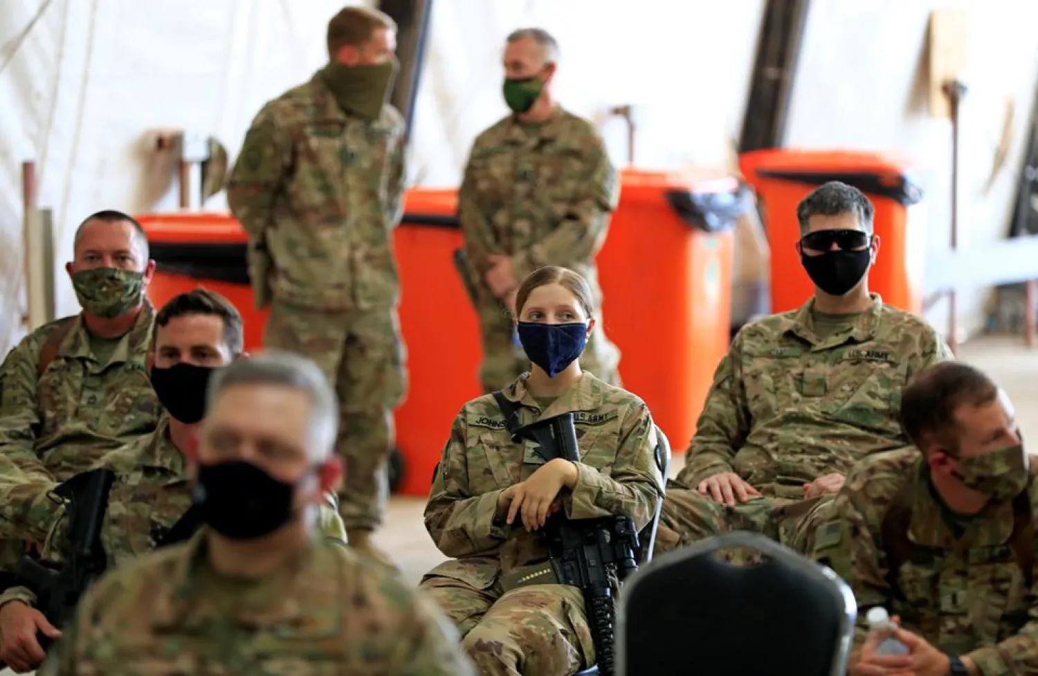US soldiers wearing protective masks are seen during a handover ceremony of Taji military base from US-led coalition troops to Iraqi security forces, in the base north of Baghdad, Iraq August 23, 2020. REUTERS/Thaier Al-Sudani/File Photo