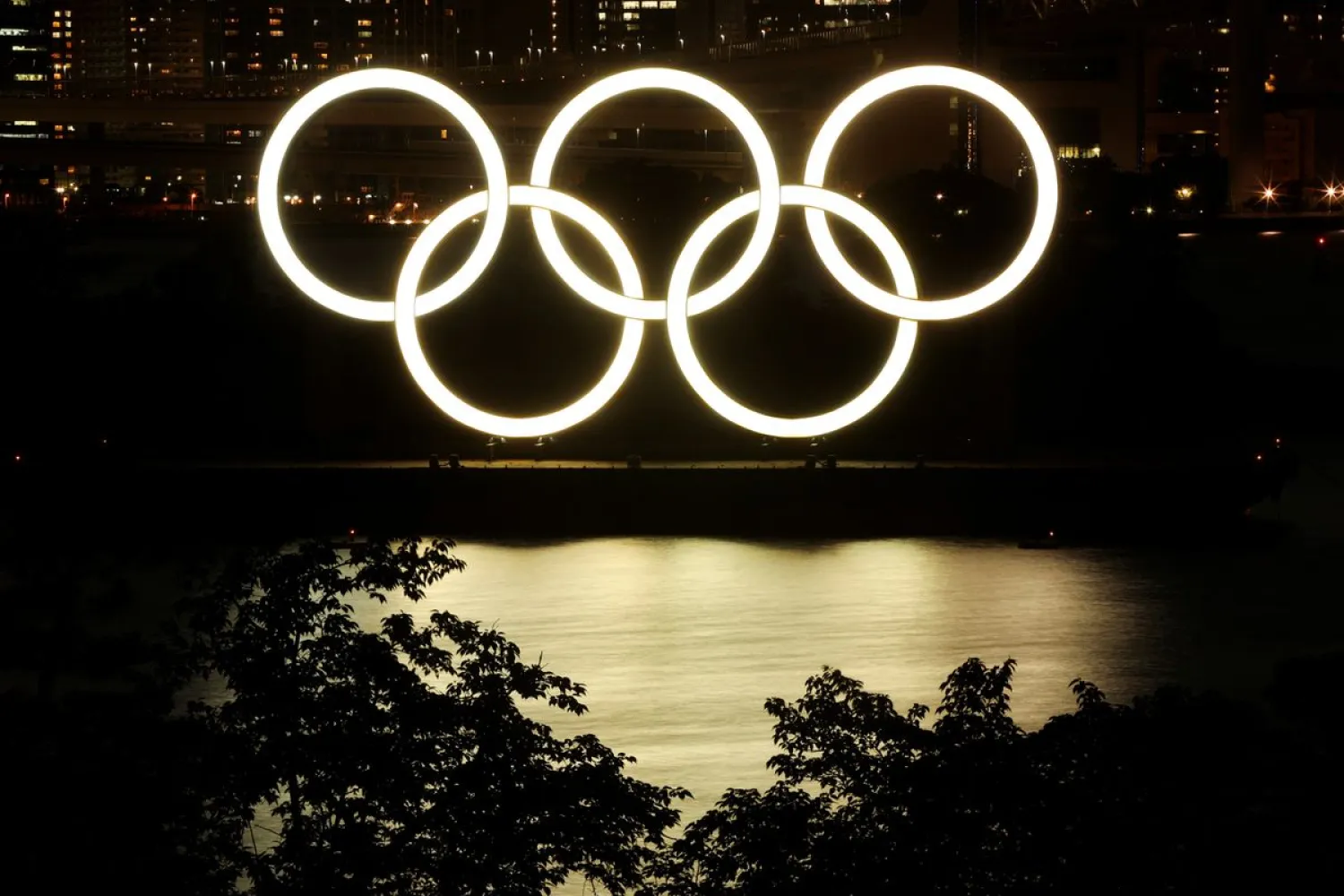 A general view of the Olympic Rings installed on a floating platform are seen in preparation for the Tokyo 2020 Olympic Games in Tokyo, Japan June 21, 2021. Picture taken with long exposure. REUTERS/Pawel Kopczynski