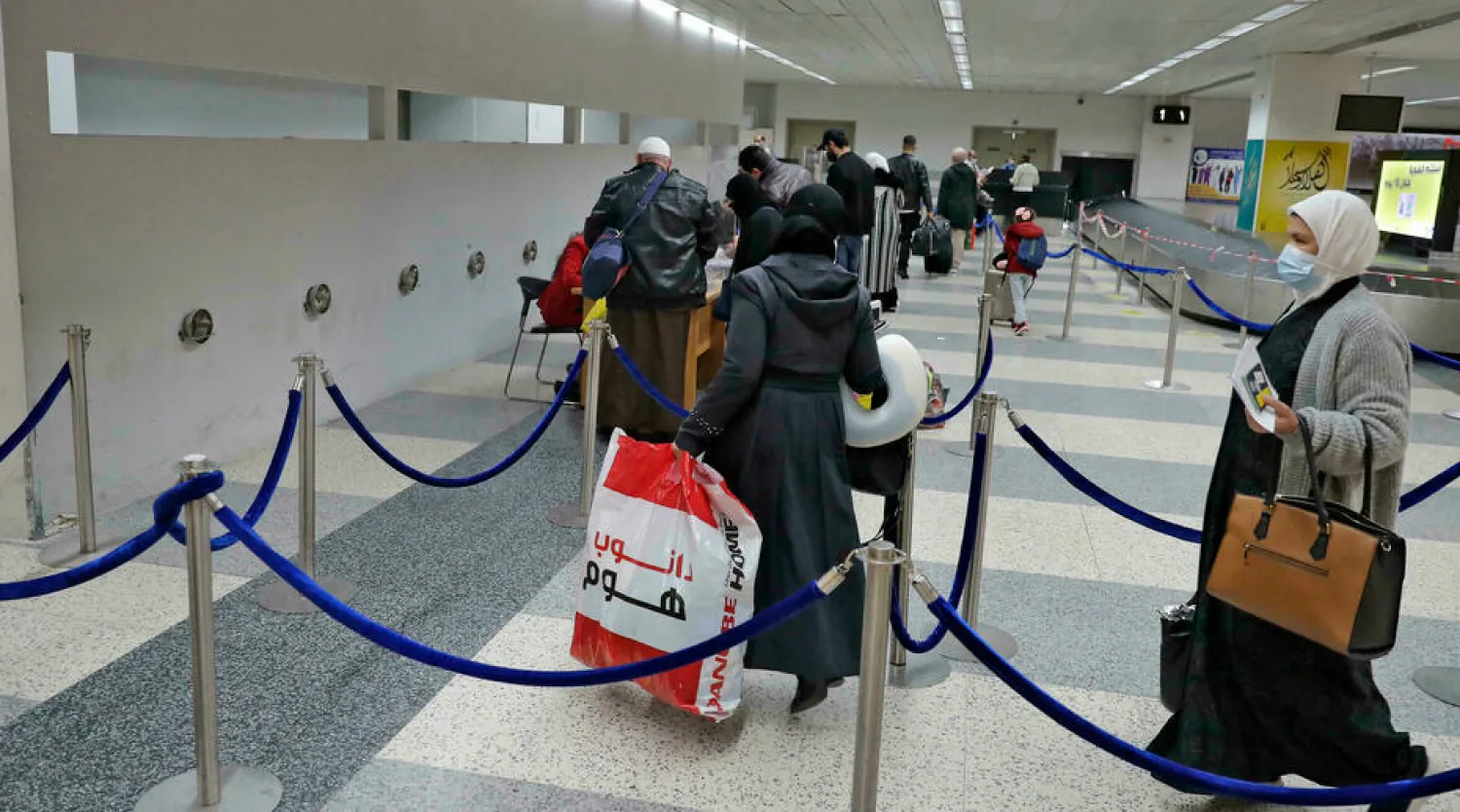 Arrivals queue to get tested for Covid at Beirut airport. A flood of Lebanese expats flying home for the summer has raised fears of a new wave of infection the crisis-hit country is simply unable to handle JOSEPH EID AFP/File
