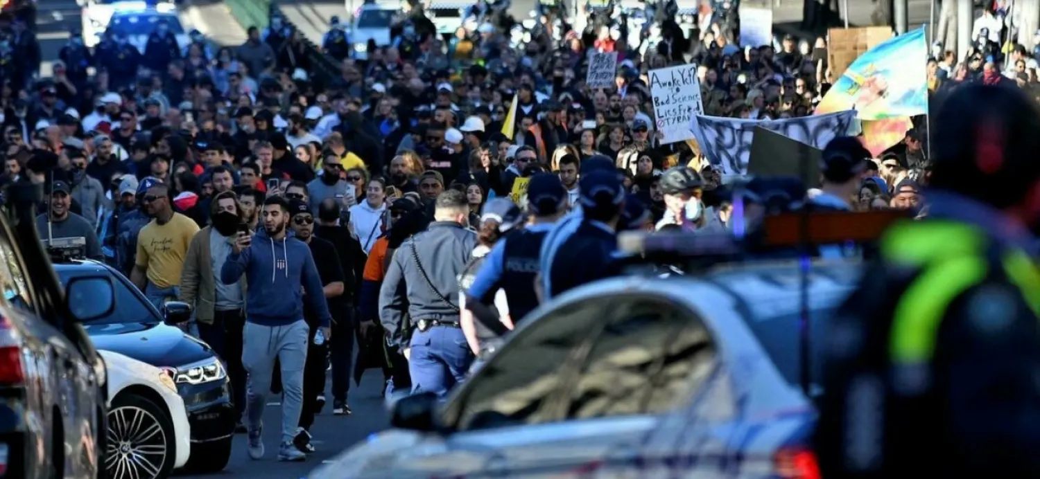 Police block the path of protesters during an anti-lockdown rally in Sydney, July 24, 2021. Steven Saphore, AFP