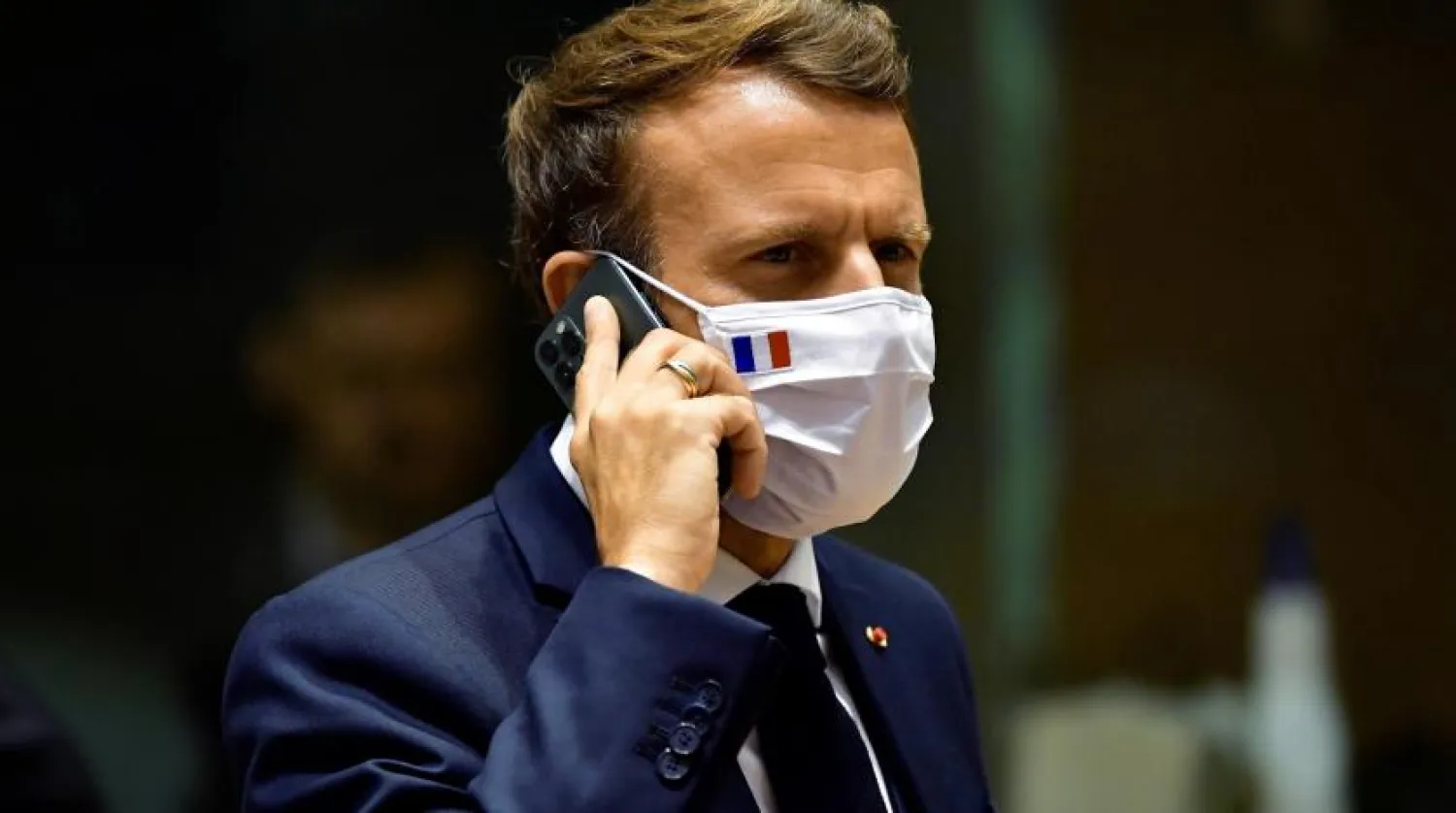 FILE - In this Monday, July 20, 2020 file photo, French President Emmanuel Macron speaks on his mobile phone during a round table meeting at an EU summit in Brussels. (John Thys, Pool Photo via AP, File)
