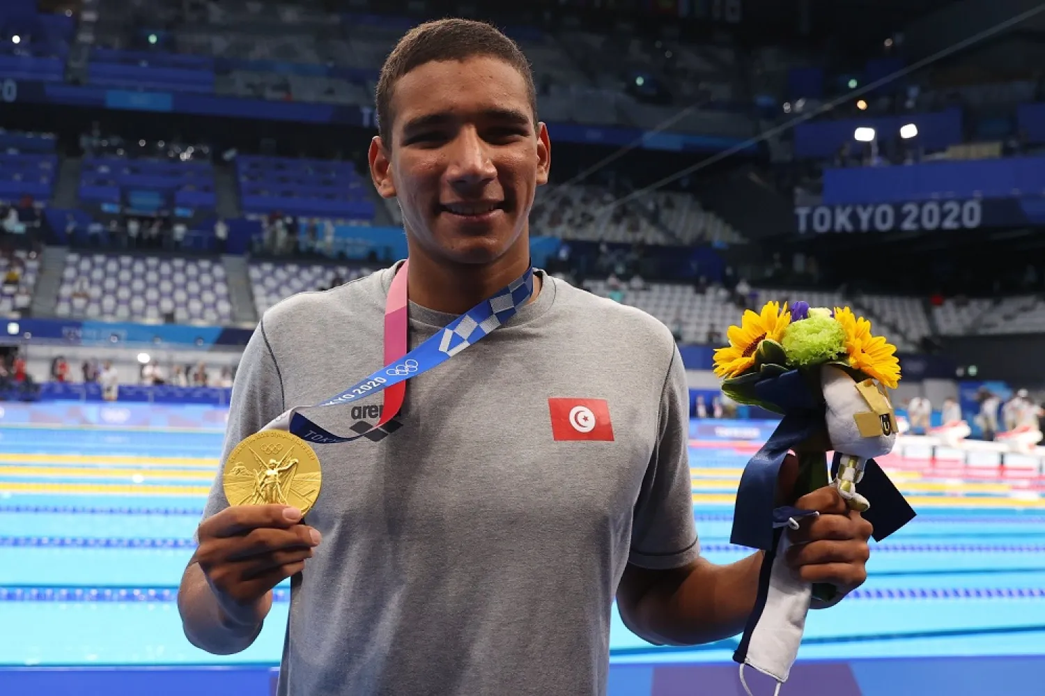 Gold medalist Ahmed Hafnaoui of Tunisia on the podium. (Reuters)