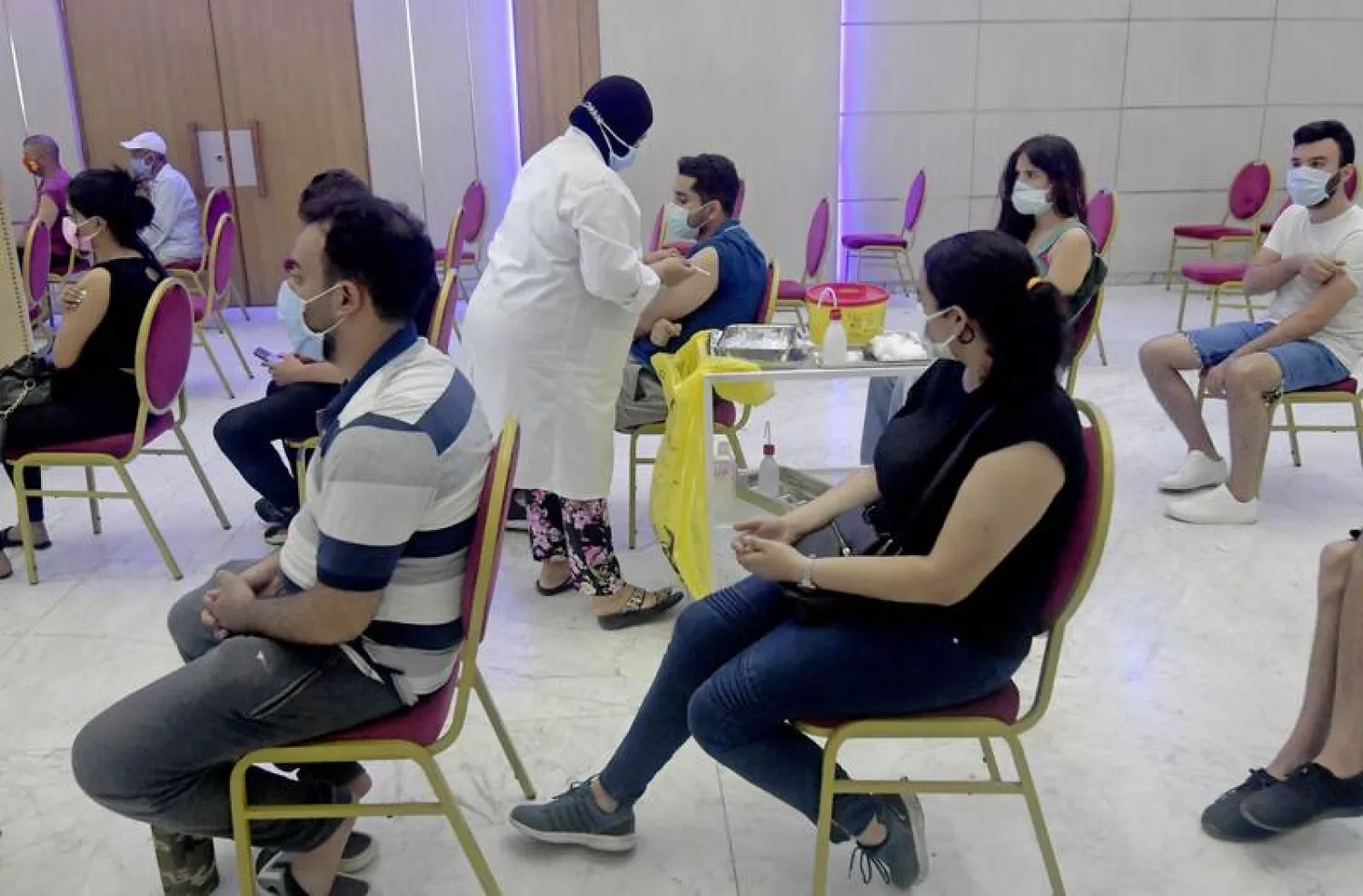 Tunisians wait to receive a dose of the Sinopharm vaccine in the capital, Tunis. (AFP)