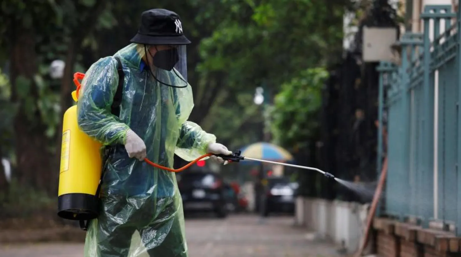 A man wearing protective clothing sprays disinfectant during the coronavirus disease (COVID-19) outbreak in Hanoi, Vietnam March 29, 2020. REUTERS/Kham
