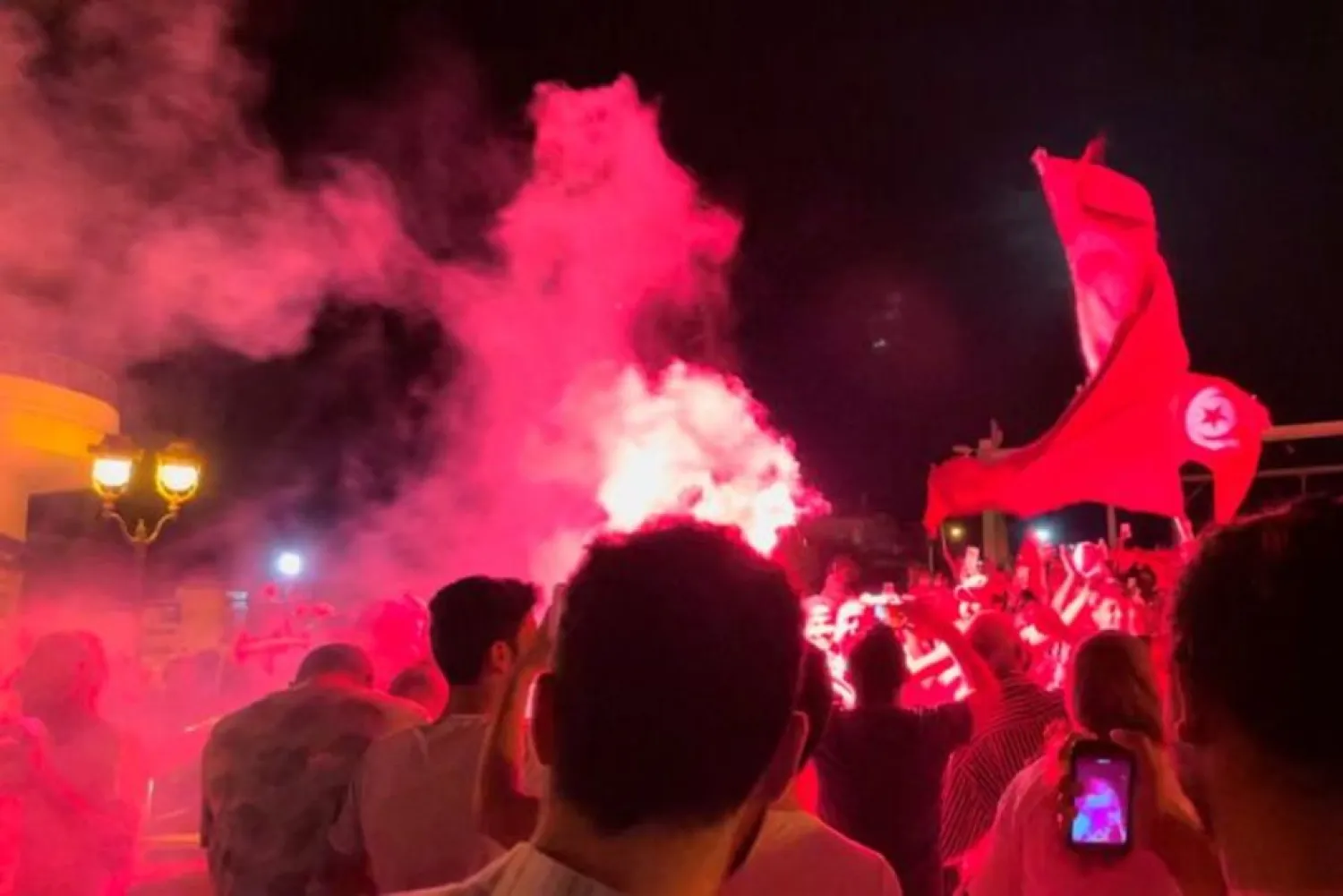 People react in the street after Tunisia’s president dismissed the government and froze parliament, in La Marsa, Tunisia, July 26, 2021 in this still image obtained from a social media video. (Reuters)