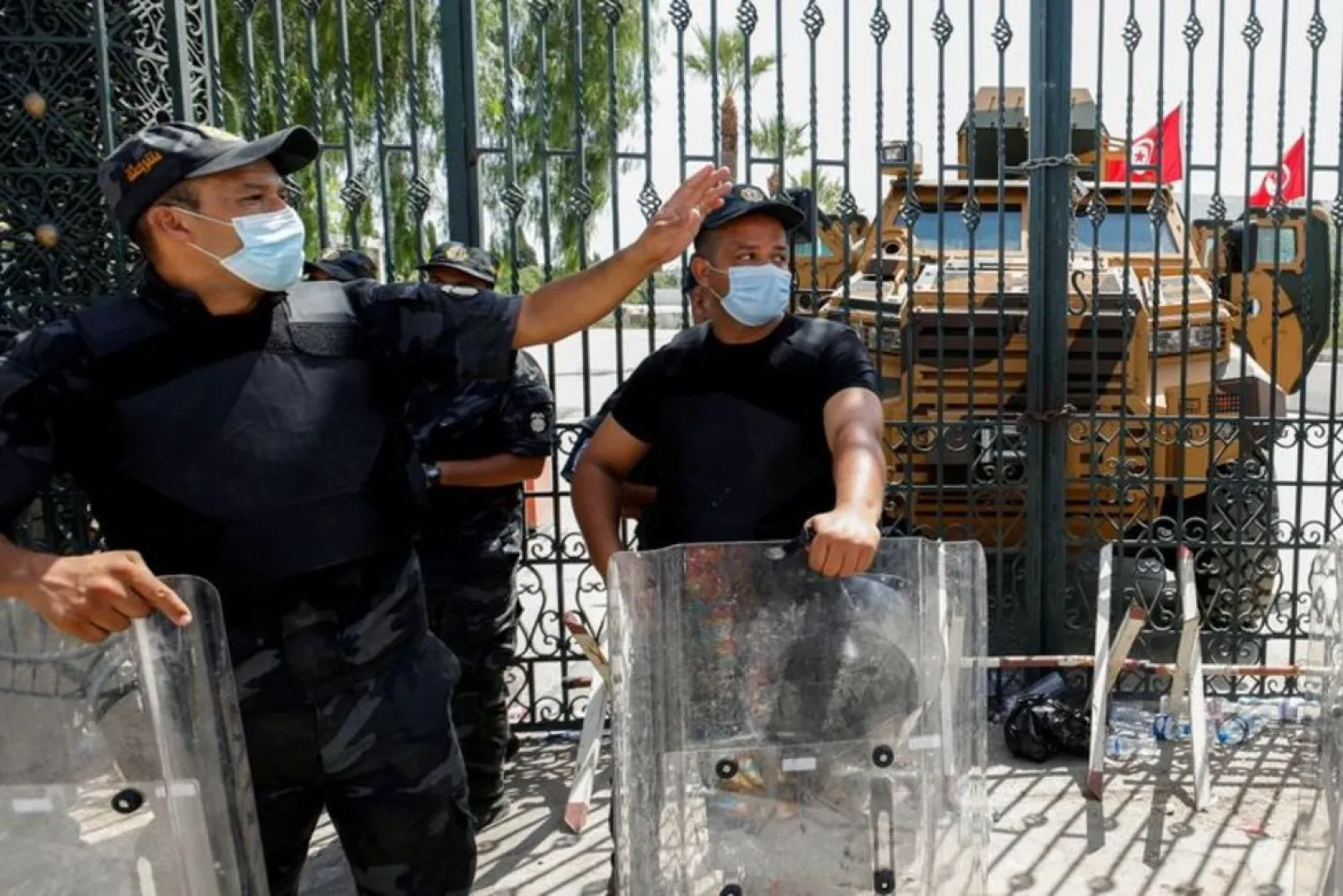 Police officers keep guard as Ennahda supports gather outside the parliament building in Tunis, Tunisia July 26, 2021. (Reuters)