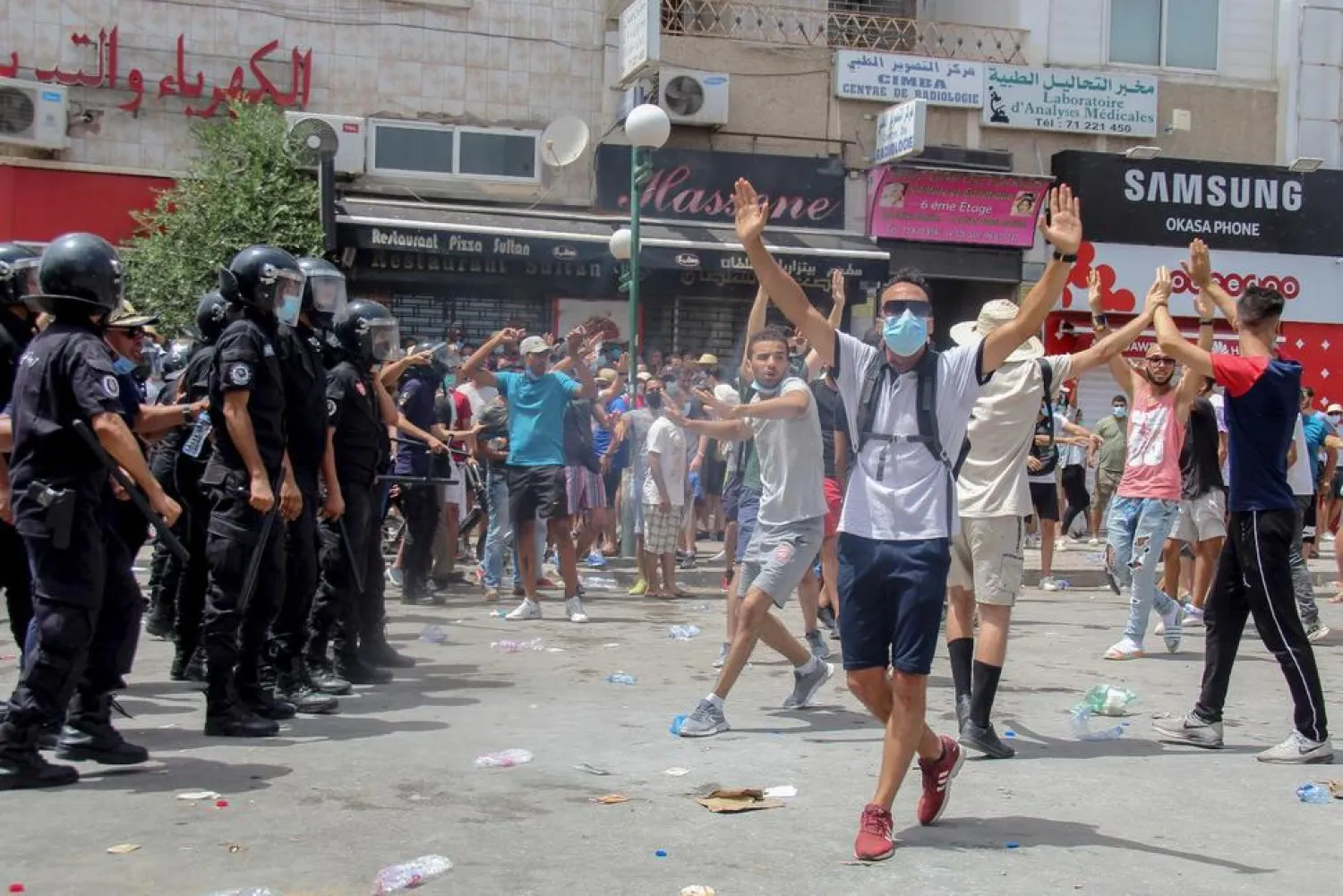 Protesters face Tunisian police officers during a demonstration in Tunis, Tunisia, Sunday, July 25, 2021. (AP)