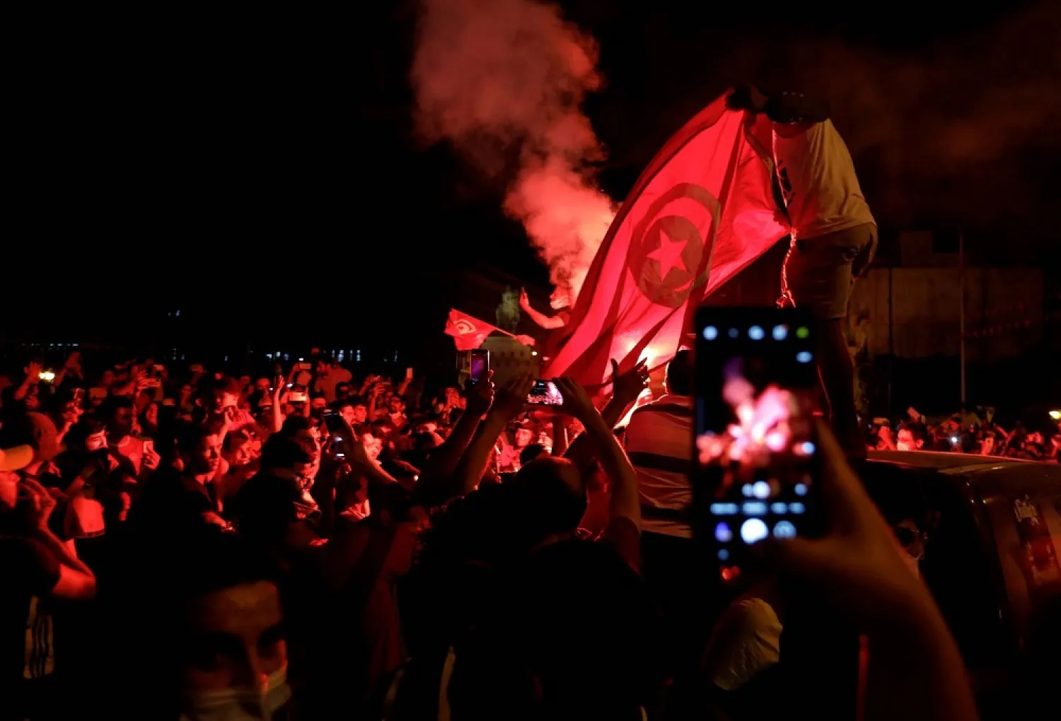 Supporters of Tunisia’s President Kais Saied gather on the streets, on Sunday. (Reuters)