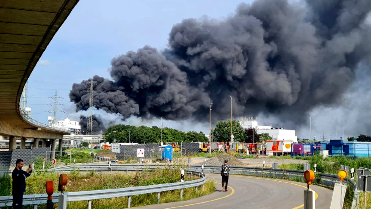 A dark cloud of smoke rises above the chemical park in Leverkusen, Germany, Tuesday, July 27, 2021. Firefighters from the site fire department are on duty. (Mirko Wolf/dpa via AP)

