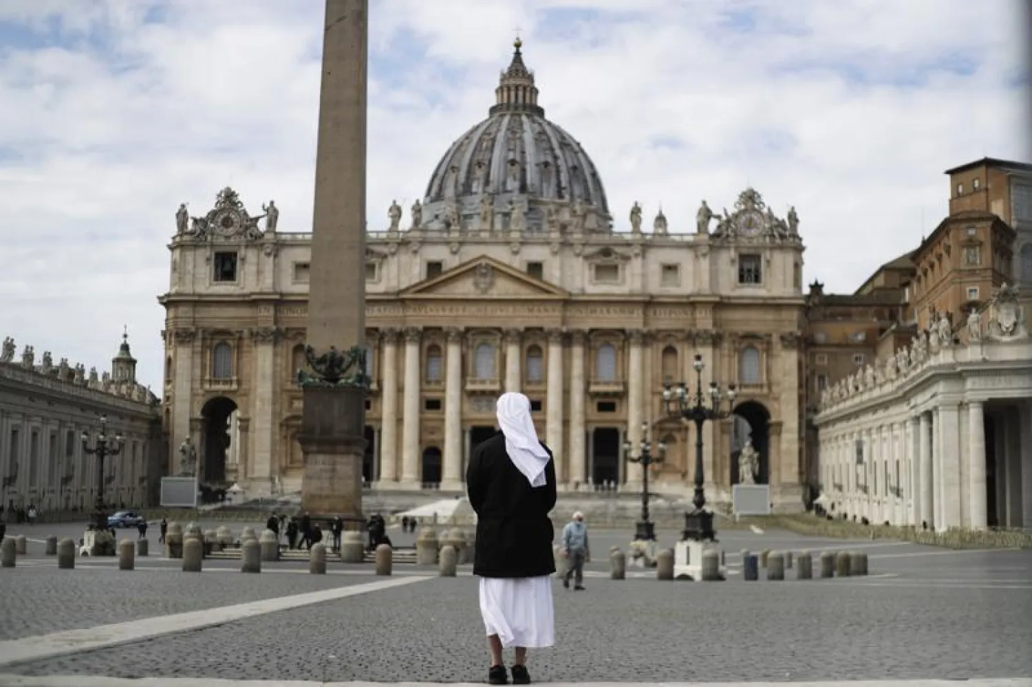 FILE - In this Sunday, March 21, 2021 filer, a nun stands in St. Peter's Square at the Vatican. Vatican prosecutors have alleged a jaw-dropping series of scandals in launching the biggest criminal trial in the Vatican’s modern history, which opens Tuesday in a modified courtroom in the Vatican Museums. (AP Photo/Gregorio Borgia, File)
