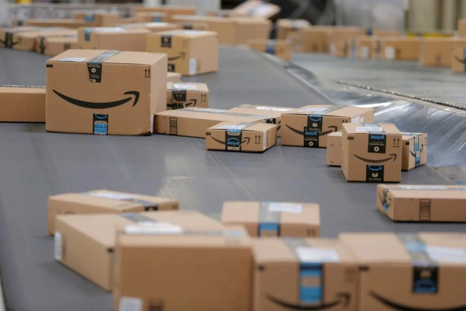 Packages emblazoned with Amazon logos travel along a conveyor belt inside of an Amazon fulfillment center in Robbinsville, New Jersey, US, November 27, 2017. (Reuters)