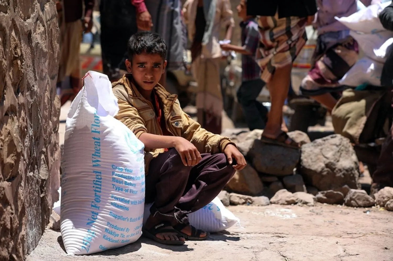 A Yemeni boy receives humanitarian aid in Taizz, Yemen on October 10, 2020. (Getty Images)