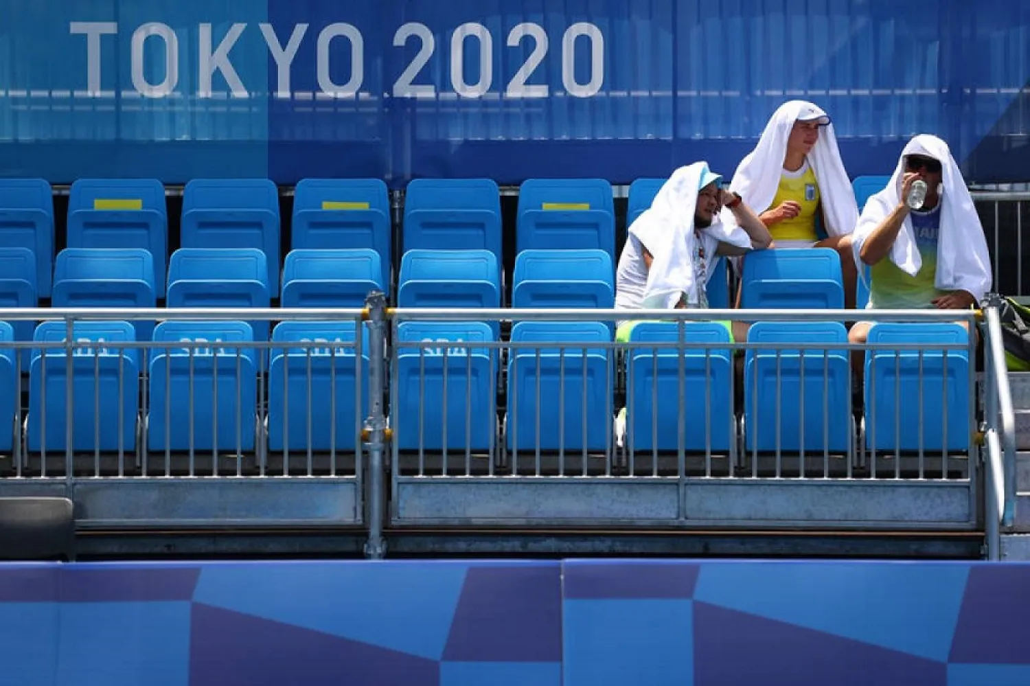 Players cool down in the hot weather at Ariake Tennis Park. (Reuters)