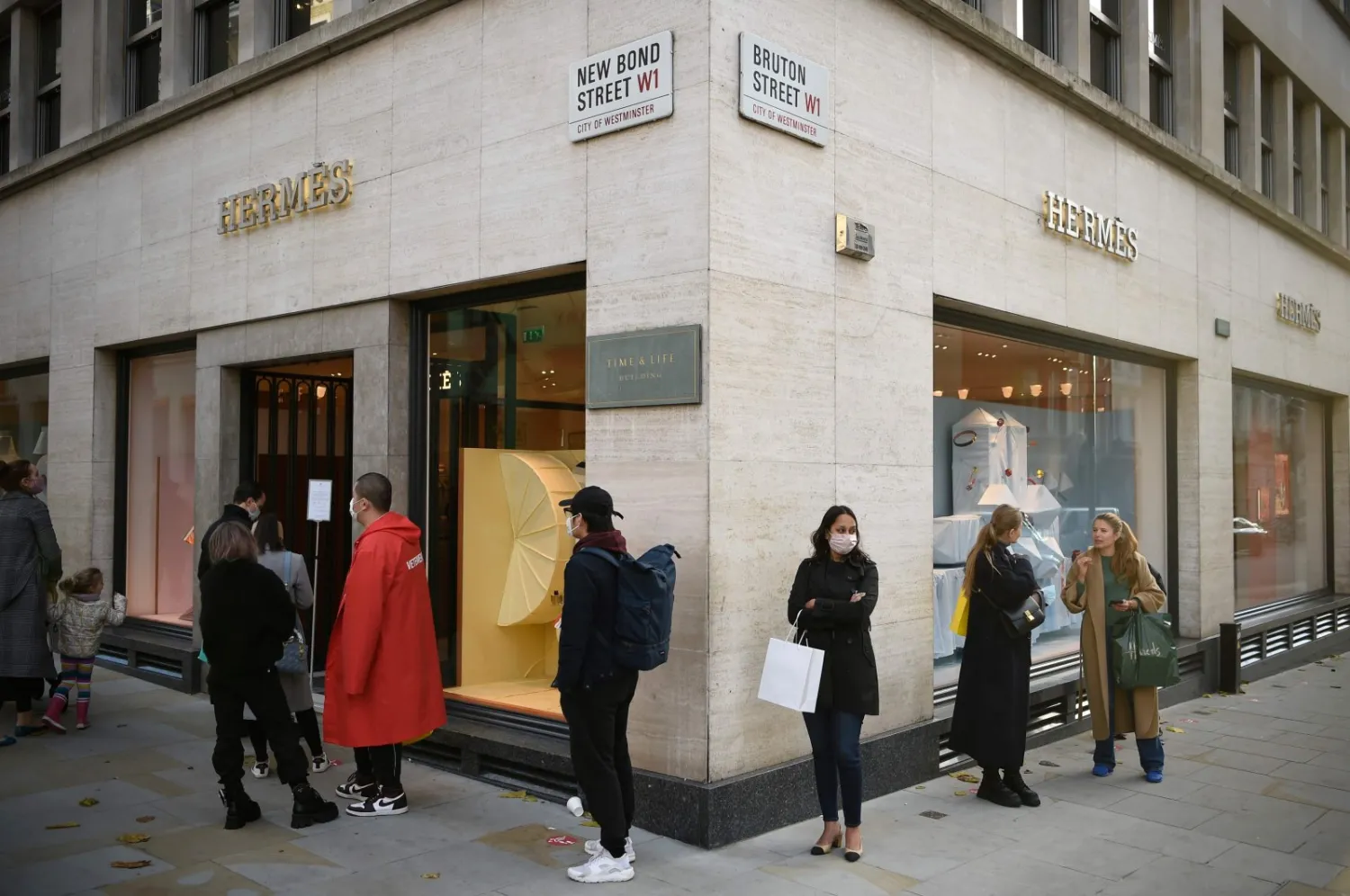 Shoppers queue to enter a branch of luxury fashion retailer Hermes in central London, Britain, Nov. 3, 2020 (AFP Photo)