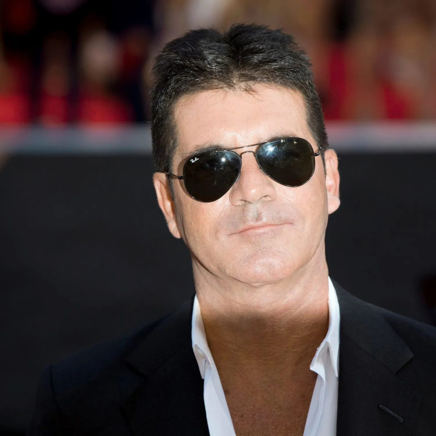 FILE PHOTO: Television mogul Simon Cowell poses for photographers as he arrives for the film "One Direction: This is Us", in London August 20, 2013. REUTERS/Neil Hall