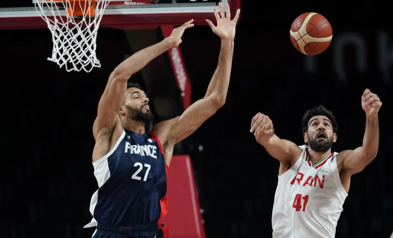 France's Rudy Gobert (27), left, and Iran's Arsalan Kazemi (41) fight for a rebound during men's basketball preliminary round game at the 2020 Summer Olympics, Saturday, July 31, 2021, in Saitama, Japan. (AP Photo/Charlie Neibergall)
