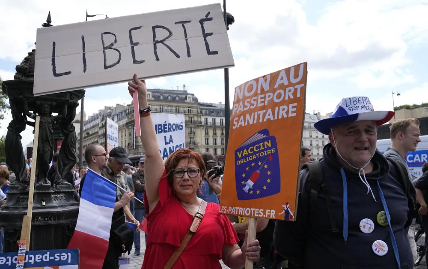 A protestor holds a sign which reads in French, “freedom” and “no to the Covid passport” as she attends a demonstration in Paris, France, Saturday, July 31, 2021. (AP)