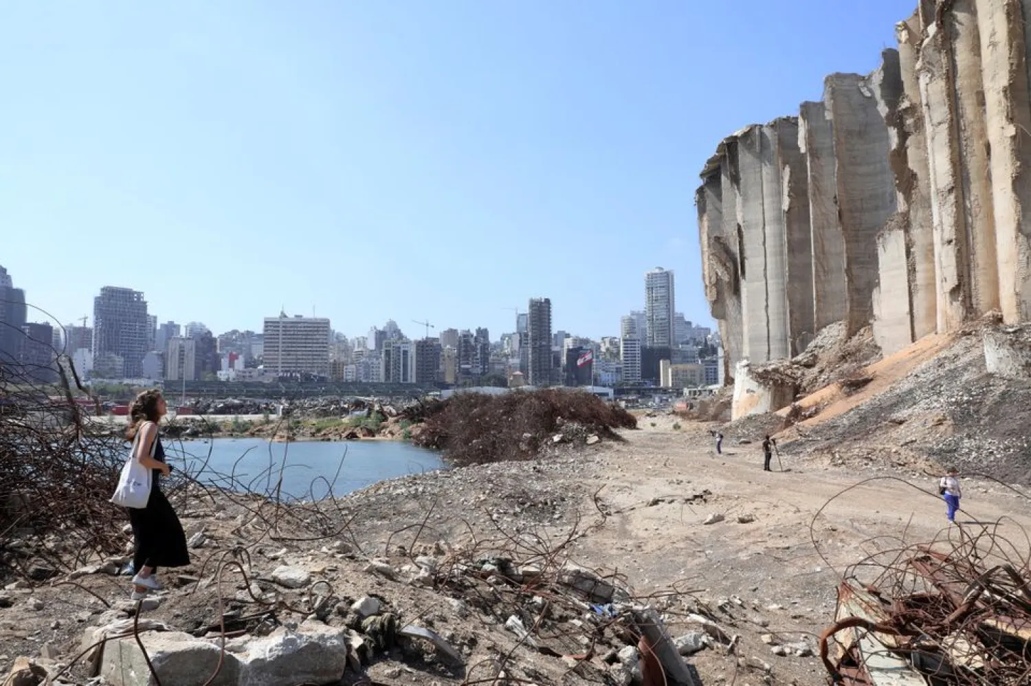 A woman walks on rubble at the site of last year's Beirut port blast, in Beirut, Lebanon July 13, 2021. REUTERS/Mohamed Azakir/File Photo