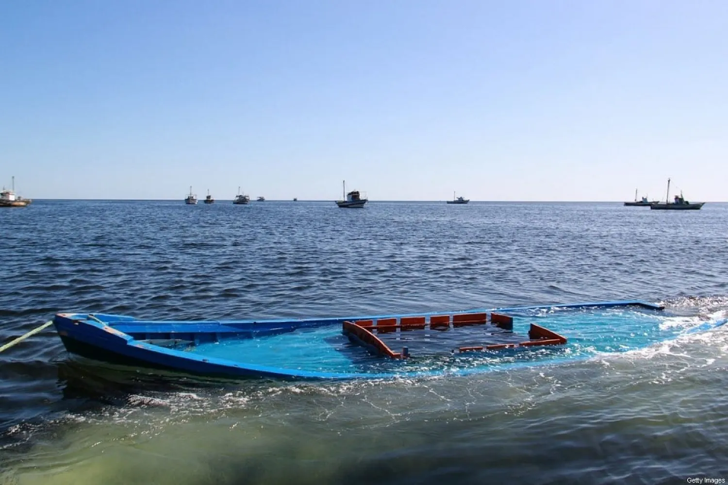 A picture taken on October 13, 2020, shows a boat, which was carrying 29 people and sank off the Tunisian coast, being towed near the Tunisian coastal town of Amra. (Getty Images)