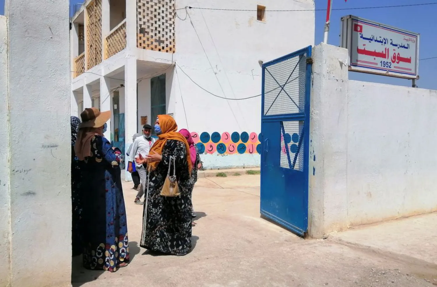People stand in a school during a vaccination campaign against coronavirus disease (COVID-19) managed by the army, in Jendouba, west of Tunis, Tunisia July 30, 2021. (Reuters)