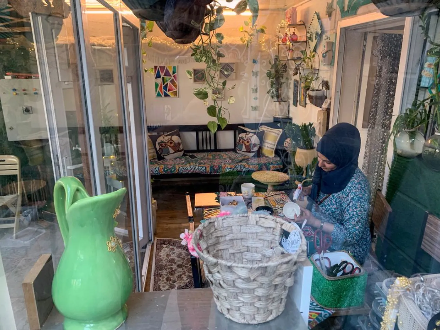 An Iraqi female petroleum engineer, who could not find a job in the oil sector, works on traditional antiques and Iraqi folklore patterns at her home in Basra, Iraq July 24, 2021. (Reuters)