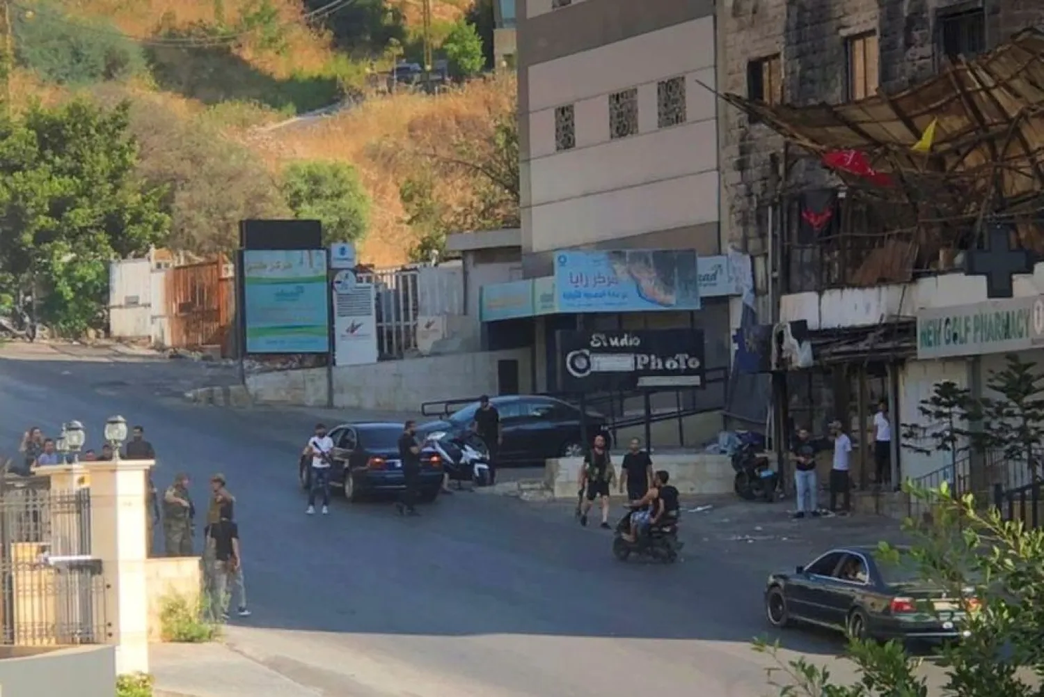 People stand in a street after an ambush on mourners in Khaldeh, Lebanon August 1, 2021. (Reuters)