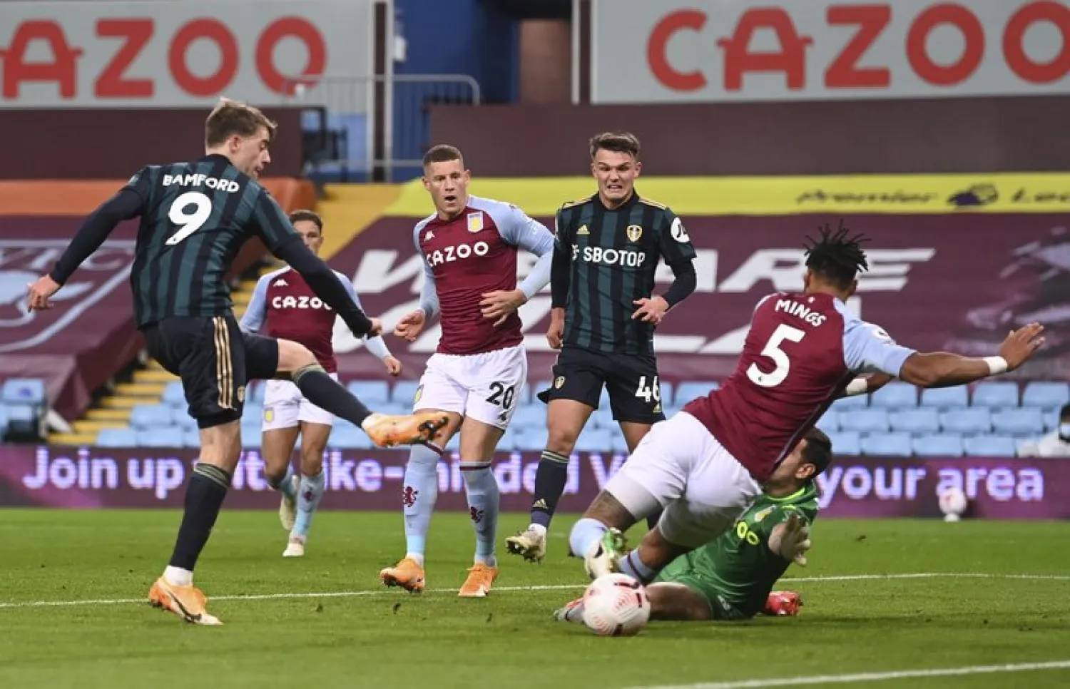 Leeds United's Patrick Bamford, left, shoots to score during the English Premier League soccer match between Aston Villa and Leeds United at Villa Park in Birmingham, England, Friday, Oct. 23, 2020. (Laurence Griffiths/Pool via AP)
