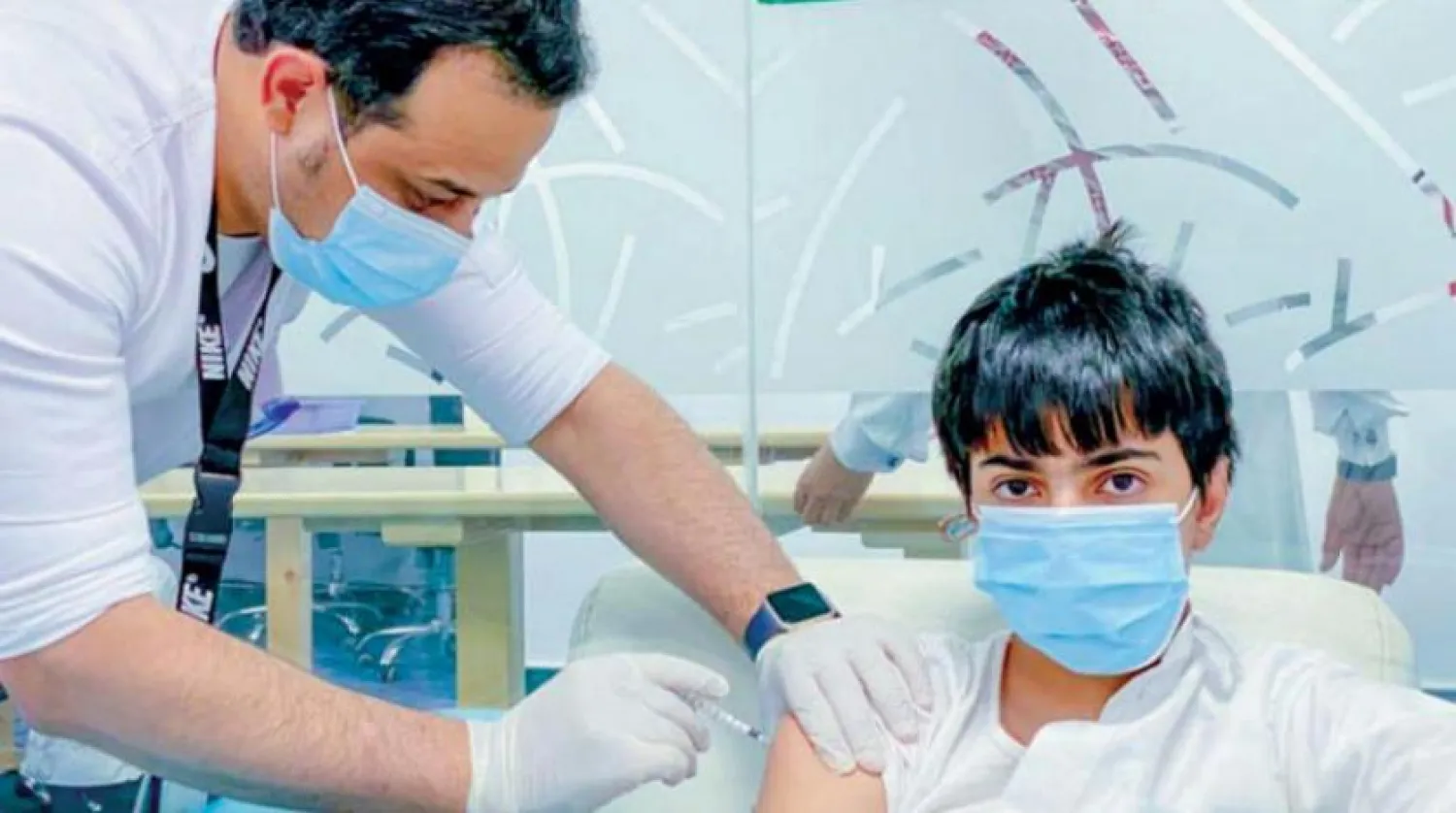 A boy receives a shot of the COVID-19 vaccine in Saudi Arabia. (Asharq Al-Awsat)