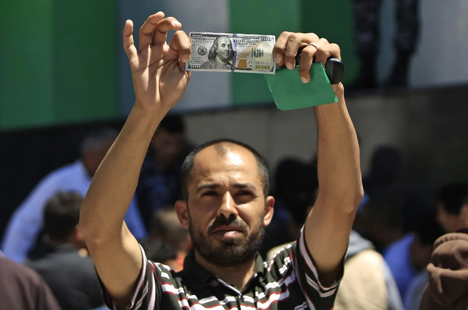 A Palestinian man shows the aid he received. (AFP)