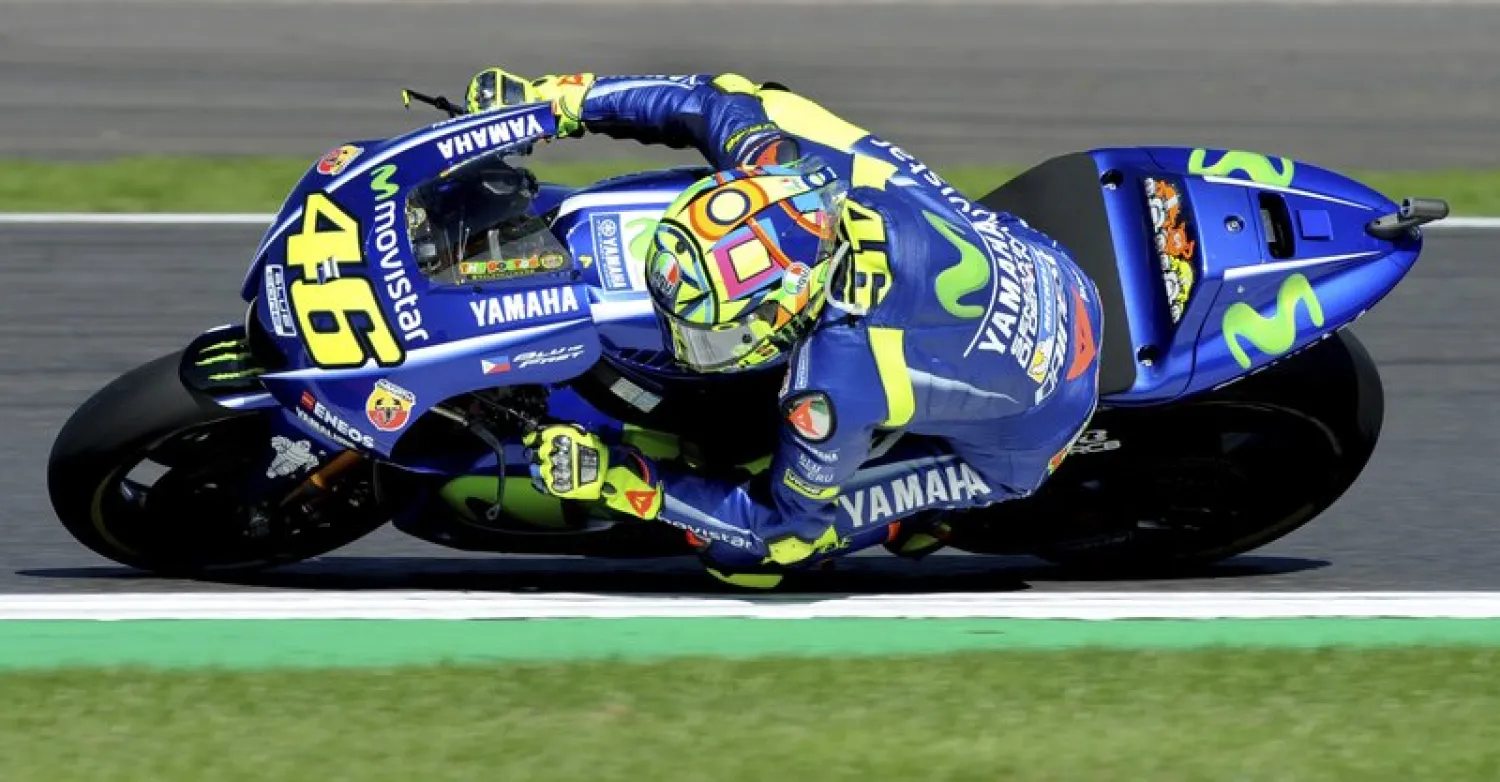 FILE -- In this Aug. 27, 2017 file photo, Italy's Valentino Rossi steers his bike during the Moto GP race at the British Grand Prix at Silverstone, England. (AP Photo/Rui Vieira)