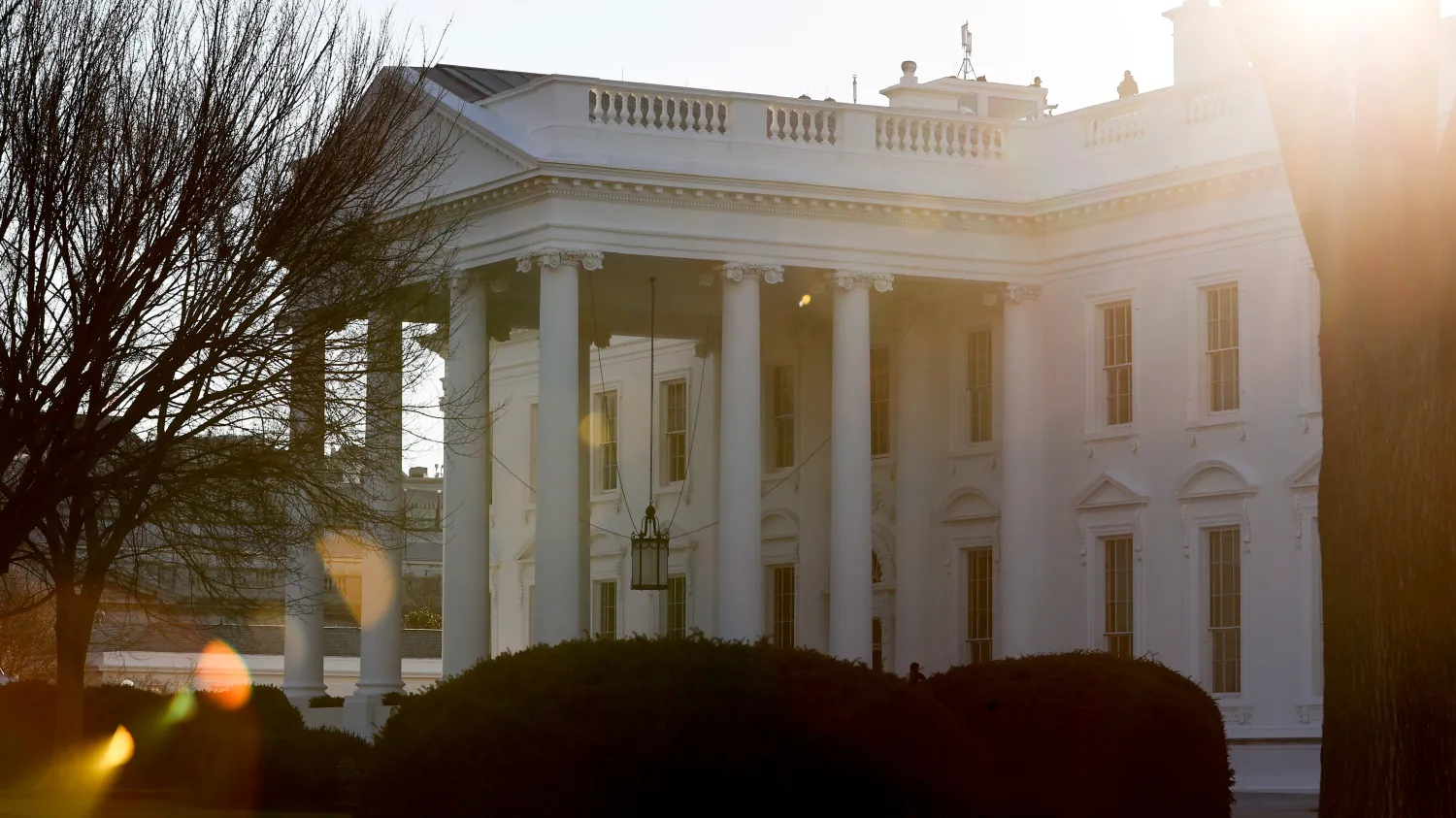 A general view of the sun rising behind the White House in Washington, U.S. January 22, 2021. REUTERS/Jonathan Ernst