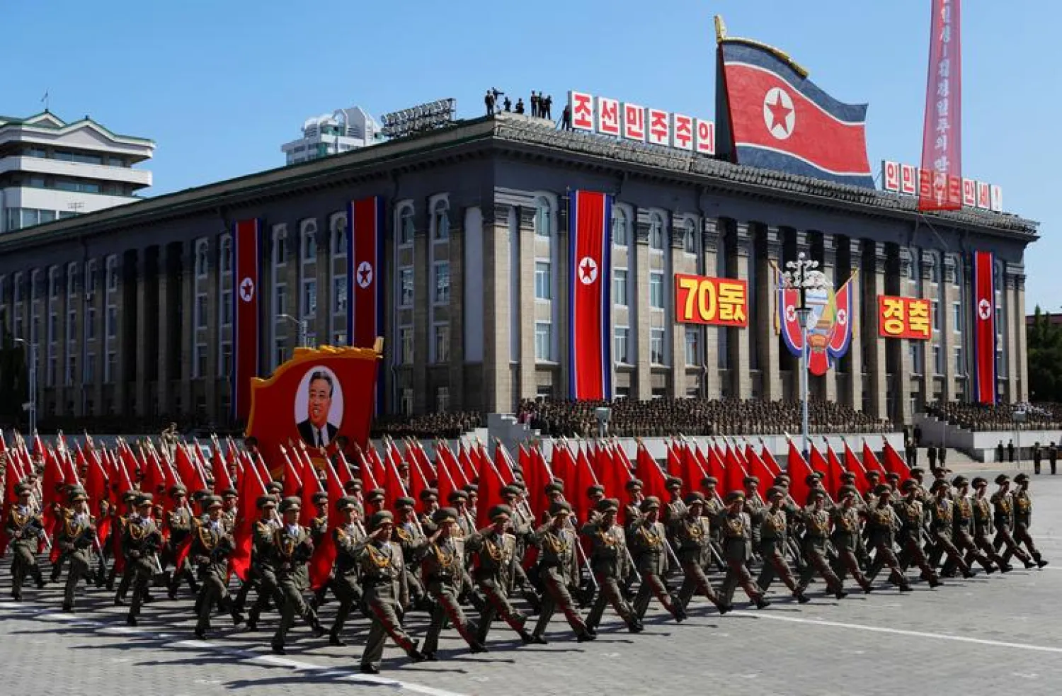 Soldiers march with the portrait of North Korean founder Kim Il Sung during a military parade marking the 70th anniversary of country's foundation in Pyongyang, North Korea. REUTERS/Danish Siddiqui

