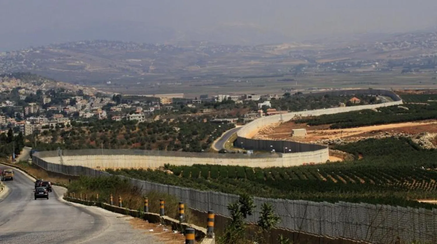 Vehicles drive along border wall with Israel near southern Lebanese village of Adaisseh. (AFP file photo)
