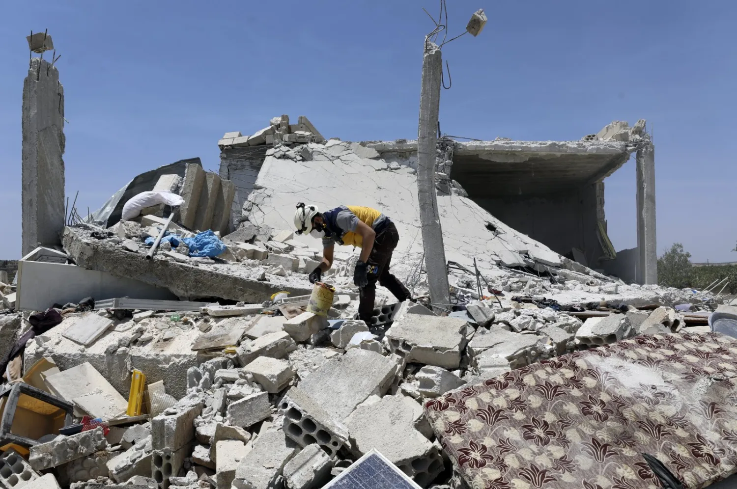 A civil defense worker inspects a damage house after shelling hit the town of Ibleen, a village in southern Idlib province, Syria, Saturday, July 3, 2021. (AP Photo)