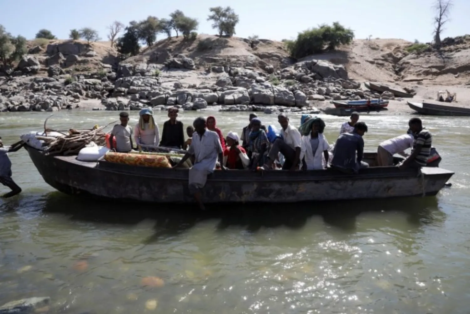 Ethiopians fleeing from the Tigray region arrive by boat to Sudan after crossing a river between the two countries, near the Hamdayet refugee transit camp, Sudan, December 1, 2020. (Reuters)