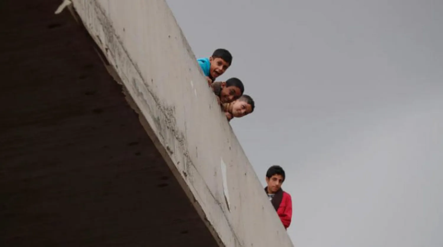 Children look out from a bridge in Sanaa, Yemen (AFP)