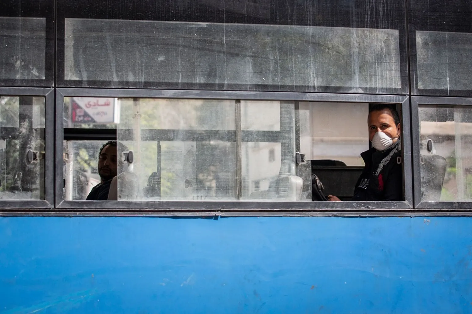 A man wearing a face mask rides in an almost empty bus in Cairo, Egypt, March 30, 2020. (dpa)