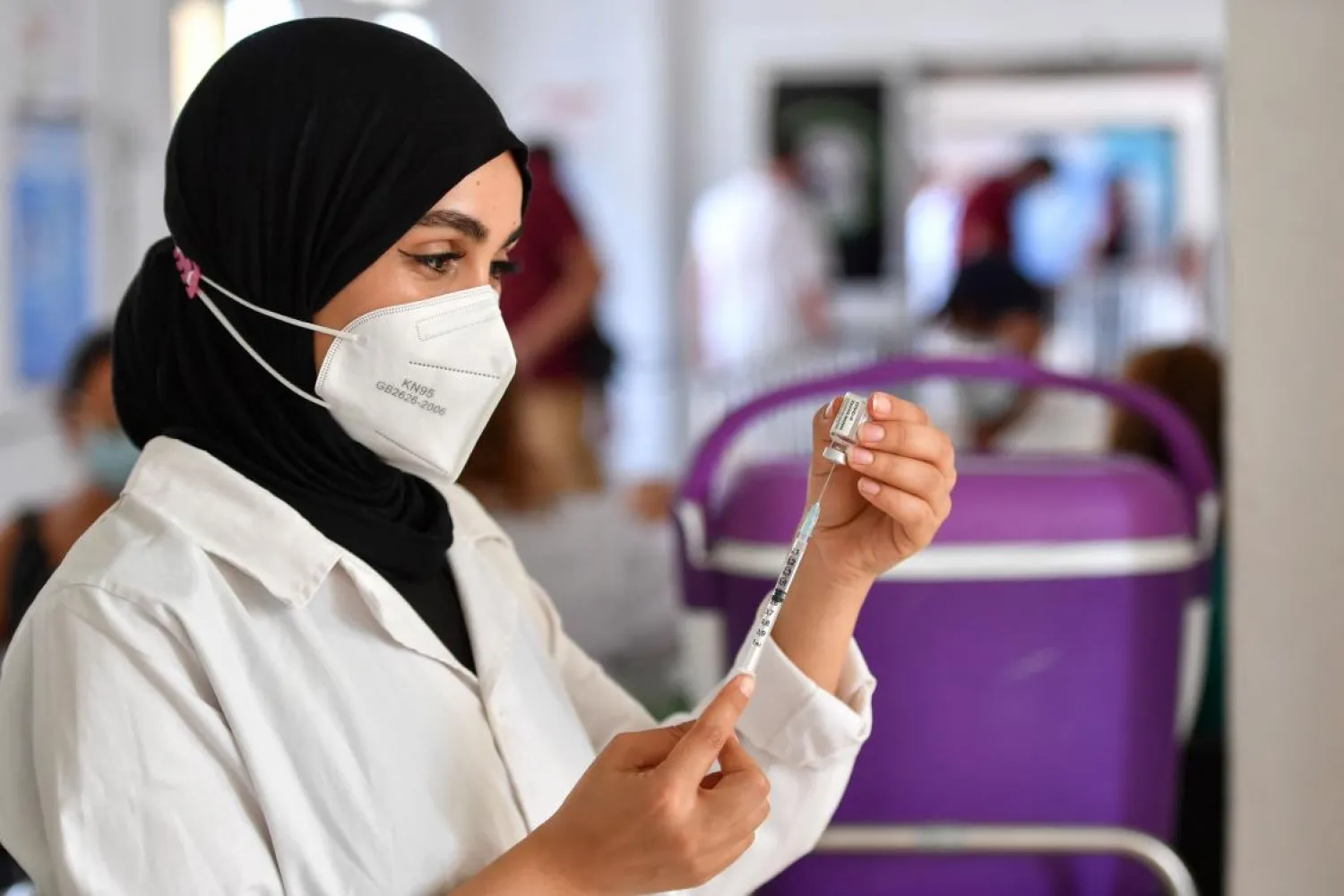 A Tunisian nurse prepares a dose of a COVID-19 vaccine at an inoculation center in Ariana governorate near the capital Tunis on August 8, 2021. (AFP)