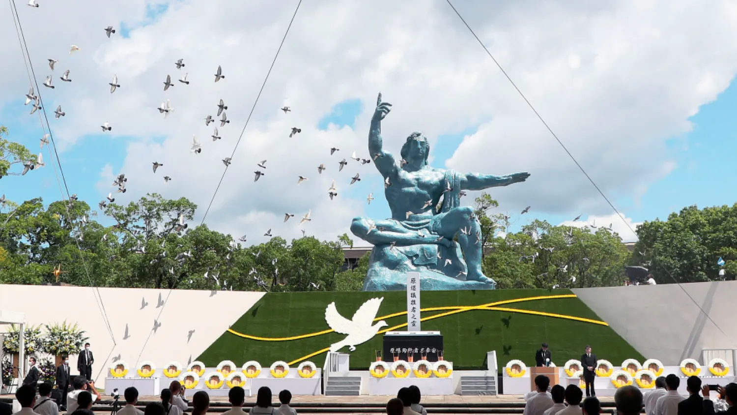 Doves fly over the Statue of Peace during a ceremony at Nagasaki Peace Park in Nagasaki, southern Japan Monday, Aug. 9, 2021. (AP)