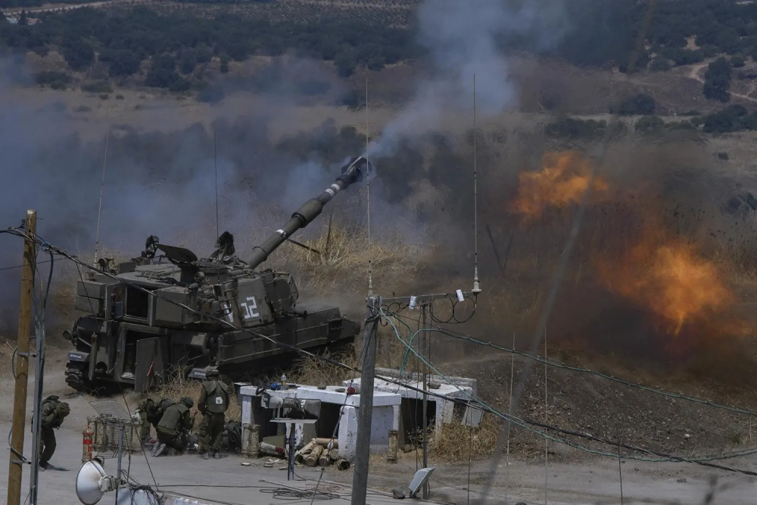Israeli forces fire artillery from their position on the border with Lebanon after a barrage of rockets were fired from Lebanon, Friday, Aug. 6, 2021. (AP)