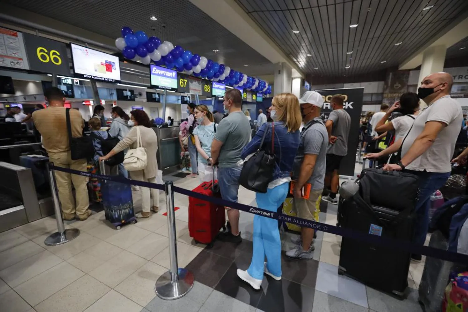 Russian tourists gather at the Egyptair check-in desk at the Domodedovo International Airport outside Moscow, Russia, Monday, Aug. 9, 2021. (AP)