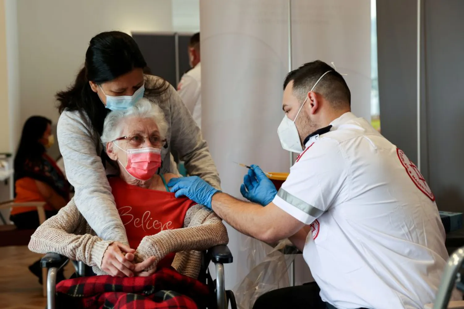 An elderly woman receives a booster shot of her vaccination against the coronavirus disease (COVID-19) at an assisted living facility, in Netanya, Israel January 19, 2021. (Reuters)