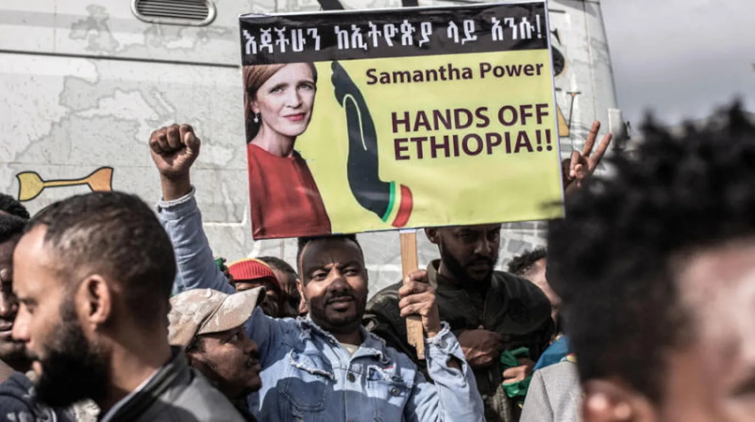مؤيدون لحكومة آبي يرفعون لافتة عليها صورة رئيسة الوكالة الأميركية للتنمية الدولية سامانثا باور تقول «كفي يدك عن إثيوبيا» (أ.ف.ب)
