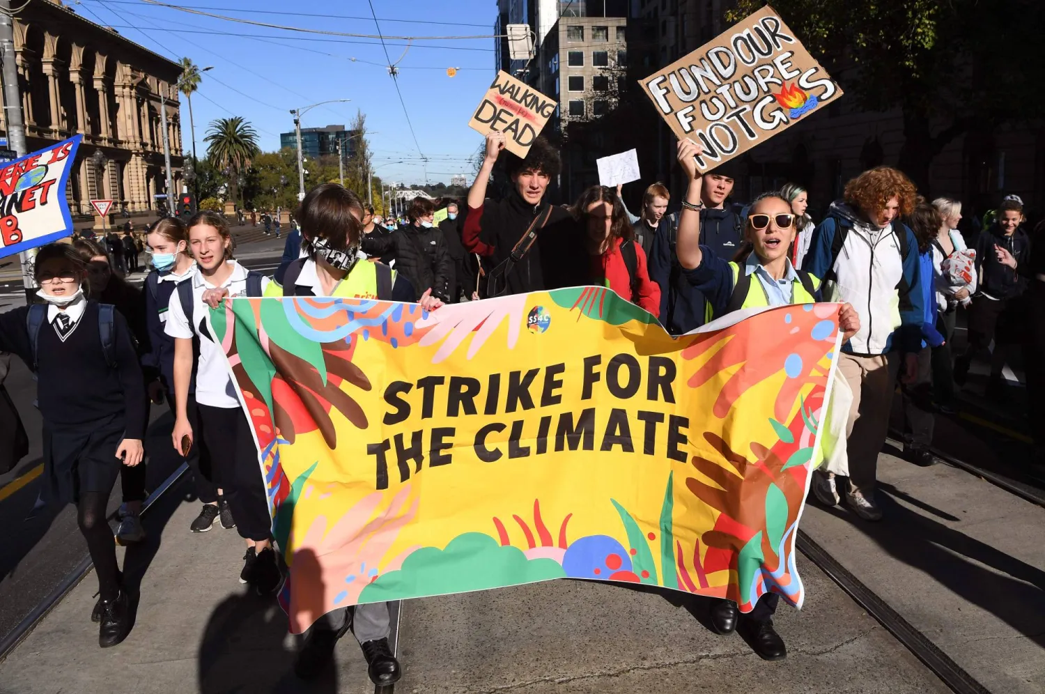 Students march during a rally calling for climate action in
Melbourne on May 21. | AFP
