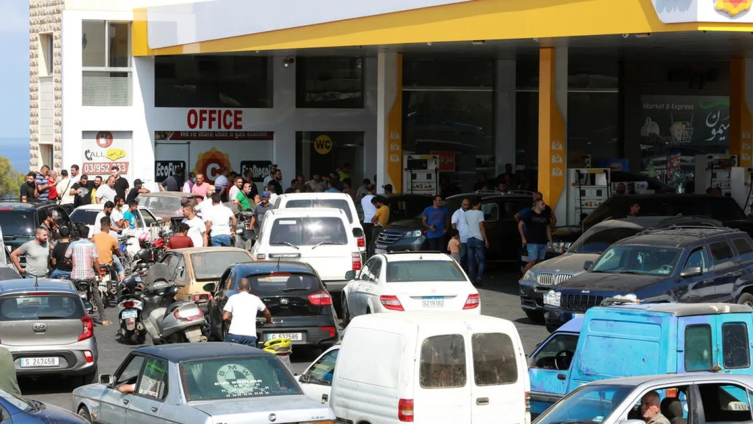 Motorbike and car drivers wait to get fuel at a gas station, after the central bank decided to effectively end subsidies on fuel imports, in Damour, Lebanon, August 13, 2021. (Reuters)
